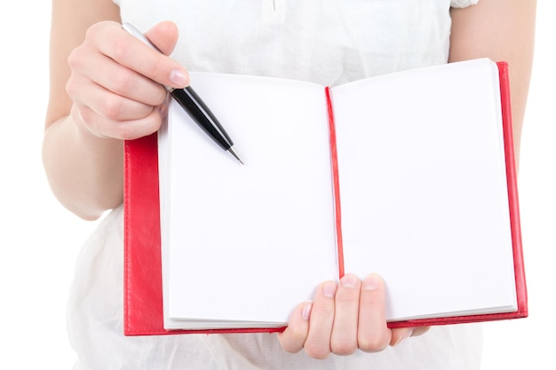 Woman hands holding blank notebook and pen isolated on white background