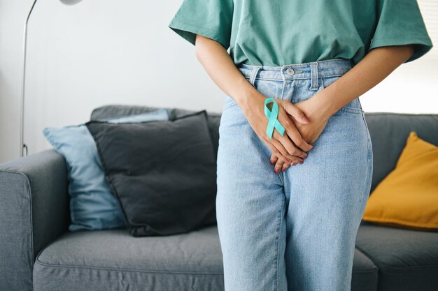 Woman hands holding closing uterus with hands protect reproductive organs Ovarian Cancer month