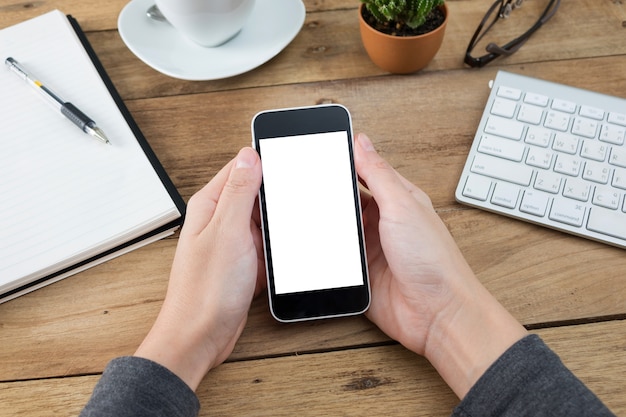 woman hands holding empty screen of smartphone on wood desk work.