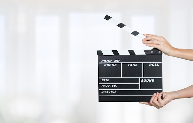 Photo woman hands holding film clapper board for making video