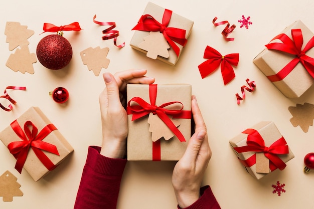 Woman hands holding gift box preparing surprise for holiday top view Christmas and New Year concept