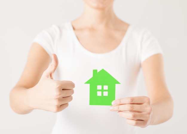 woman hands holding green house showing thumbs up