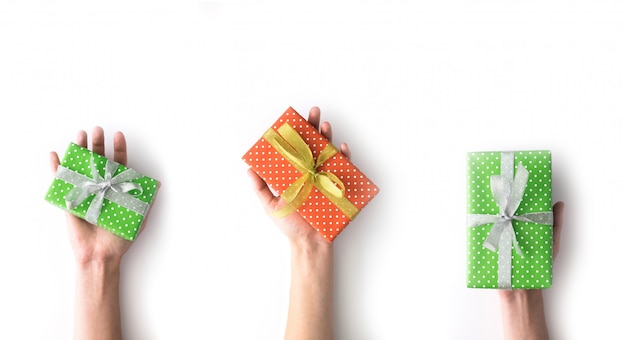 Woman hands holding green and red gift box