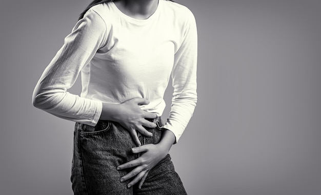 Woman Hands Holding Her Crotch Sick woman hands holding pressing her crotch lower abdomen Black and white