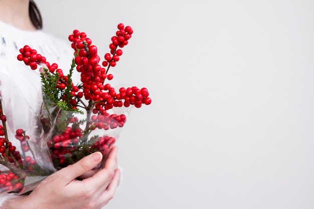 Woman hands holding ilex verticillata 