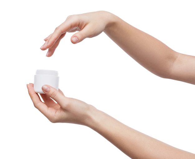 Woman hands holding jar of cream isolated on white background