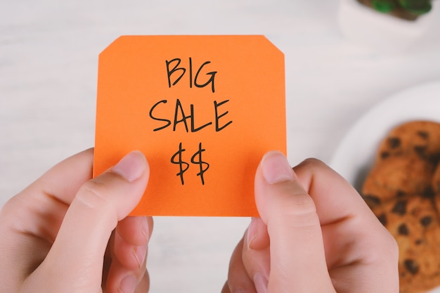 Woman hands holding note paper with text 