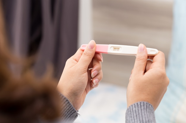 Woman hands holding ovulation test and were trying to get pregnant 