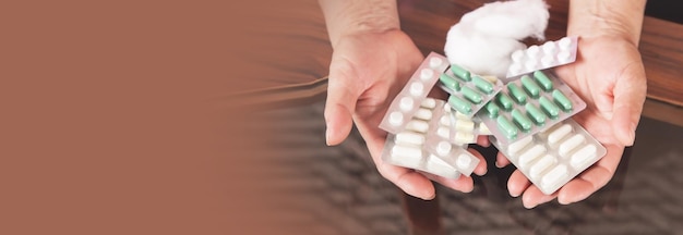 Woman hands holding a pills at home