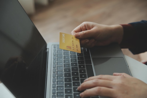 Woman hands holding and using cradit card for shopping online