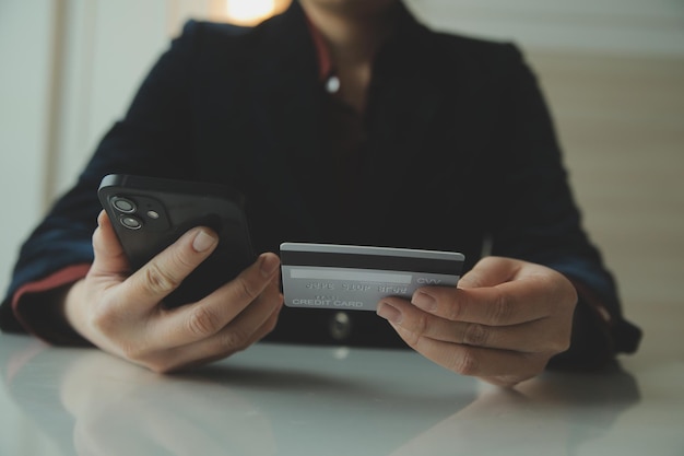 Woman hands holding and using cradit card for shopping online