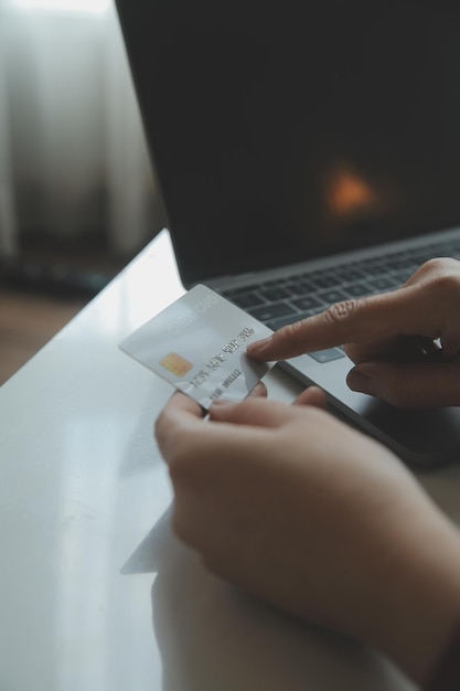 Woman hands holding and using cradit card for shopping online