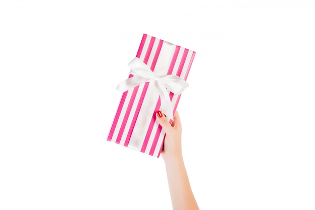 Woman hands holding a wrapped gift box 