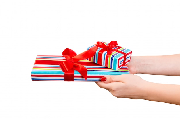 Woman hands holding a wrapped gift box 