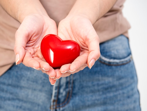 Woman hands holds red heart