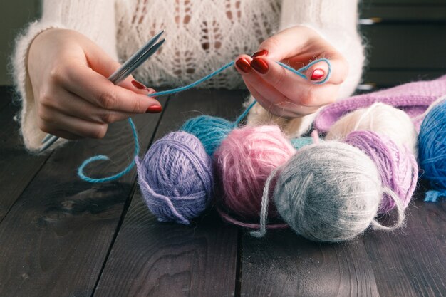 Woman hands knitting with stylish knitting needles