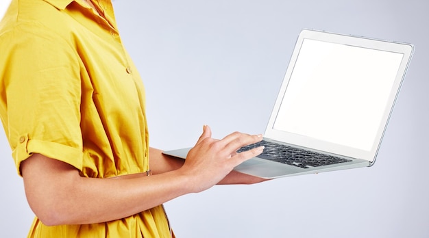 Woman hands laptop screen and presentation mockup e commerce advertising and fashion or creative website in studio Person typing on computer with space or search information on a white background