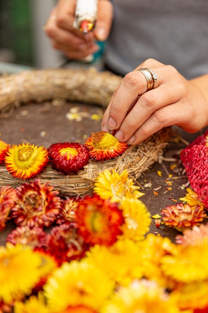 Woman hands makes an autumn wreath