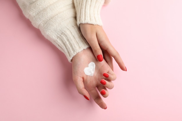 Woman hands, moisturizing cream for clean and soft skin in winter time