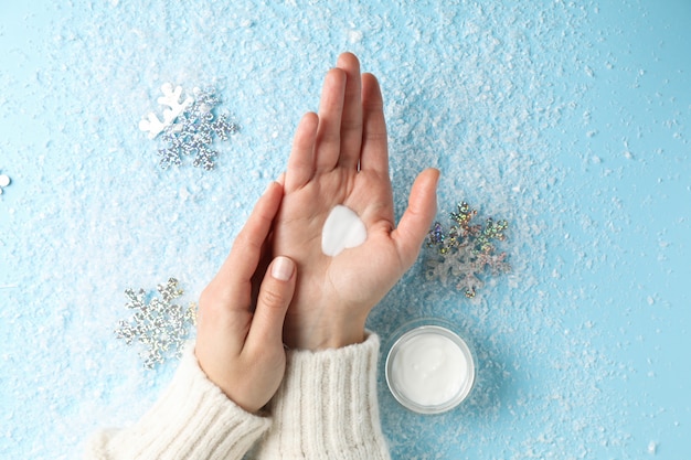 Woman hands, moisturizing cream in winter time