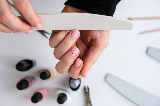 woman hands nail polish manicure tools table top view flat lay how to do manicure at home concept