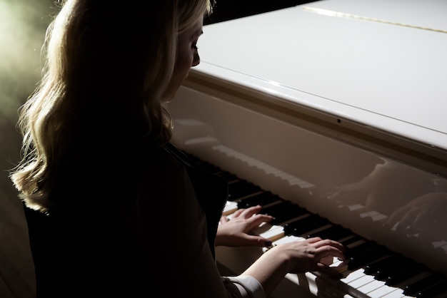 Woman hands playing a piano, musical instrument.