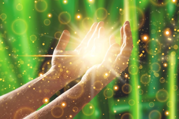 Photo woman hands praying for blessing from god, blurred nature background, rain, day.