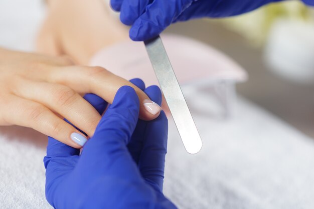 Woman hands receiving a manicure in beauty salon