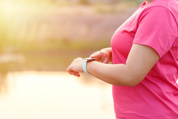 Woman hands setting smart watch Technology and people concept