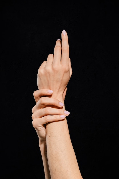 Woman hands showing different gestures on black