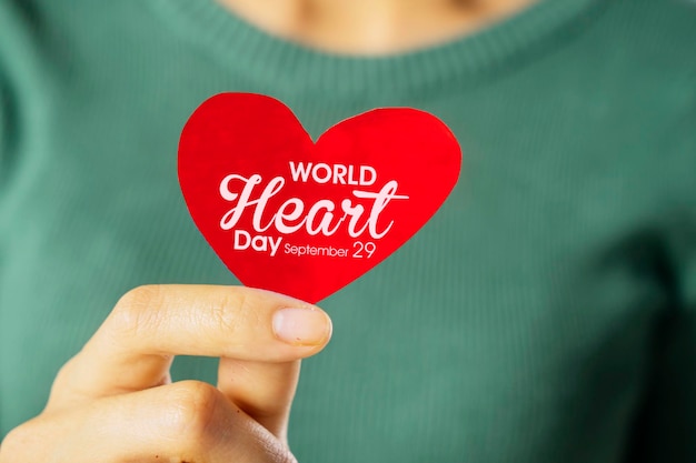 Photo woman hands showing world heart day text