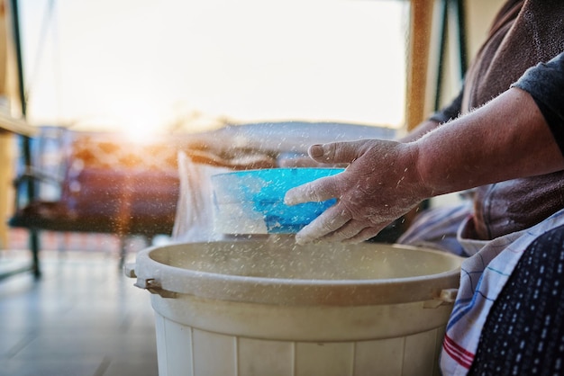 Woman hands sifting flour with flour filter