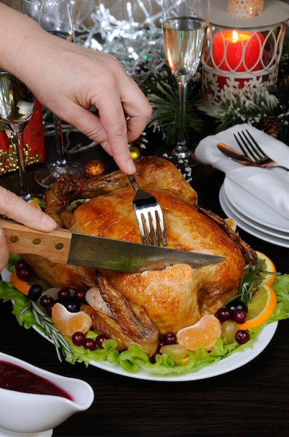 Woman hands slicing up tasty juicy spicy   appetizing  roasted whole chicken