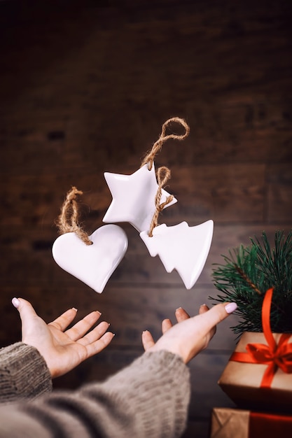 Woman hands throw up homemade christmas tree toys