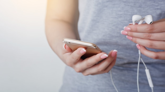 Woman hands touching smart phone close up