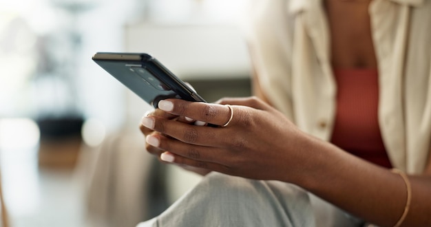 Woman hands and typing on smartphone in home reading social network notification and update multimedia subscription Closeup app and download mobile games scroll on internet and chat to contact