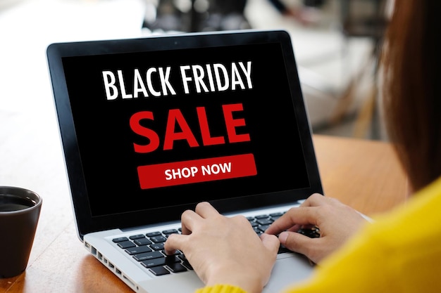 Photo woman hands using laptop computer for shopping black friday online sale