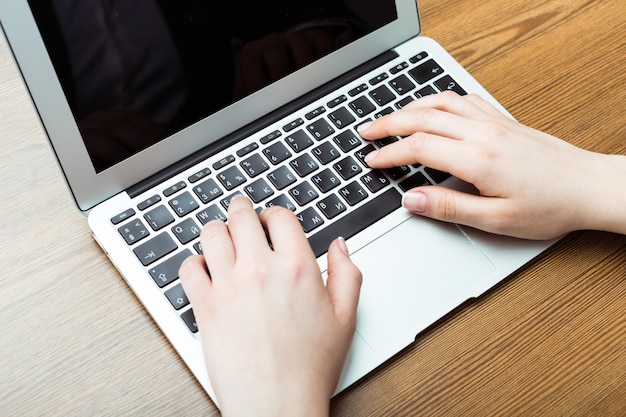 Woman hands using laptop