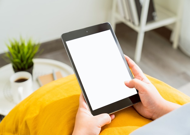 Woman hands using a tablet indoors