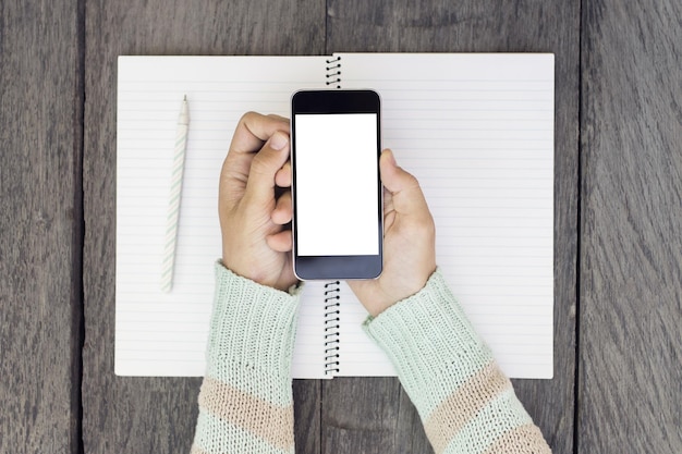 Woman hands with blank cell phone and diary mock up