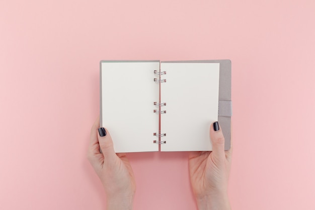 Woman hands with blank notepad 