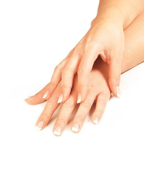 Photo woman hands with french nails on a white background