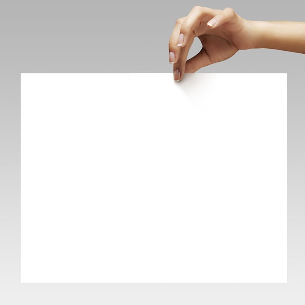 Woman hands with ideal manicure holding the white sheet of paper