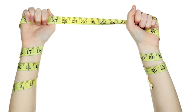 Woman hands with measuring tape isolated on white