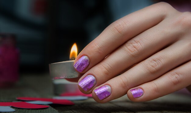 Woman hands with pink manicure.