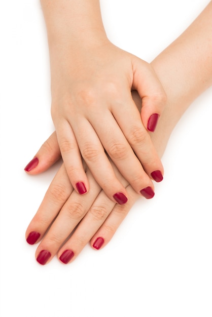 Woman hands with red nail isolated on white