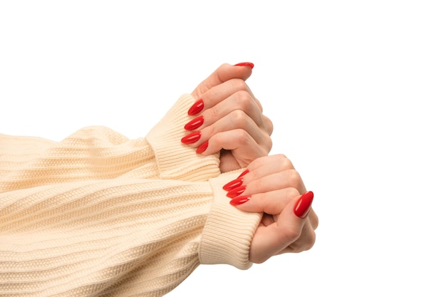 Woman hands with red nails isolated on a white background