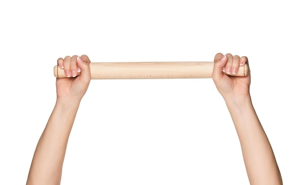 Woman hands with wooden rolling pin isolated on white background