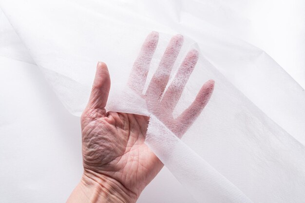 Woman hands working with Covering Roll for Medical Bed