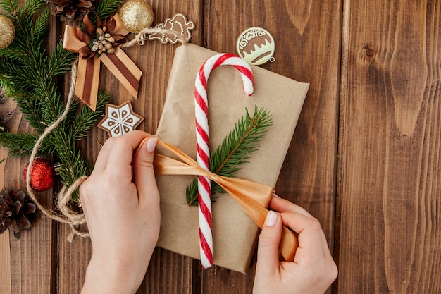 Woman hands wrapping Christmas gift